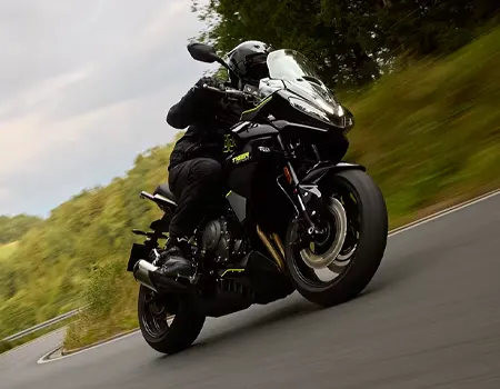 man riding a black motorcycle